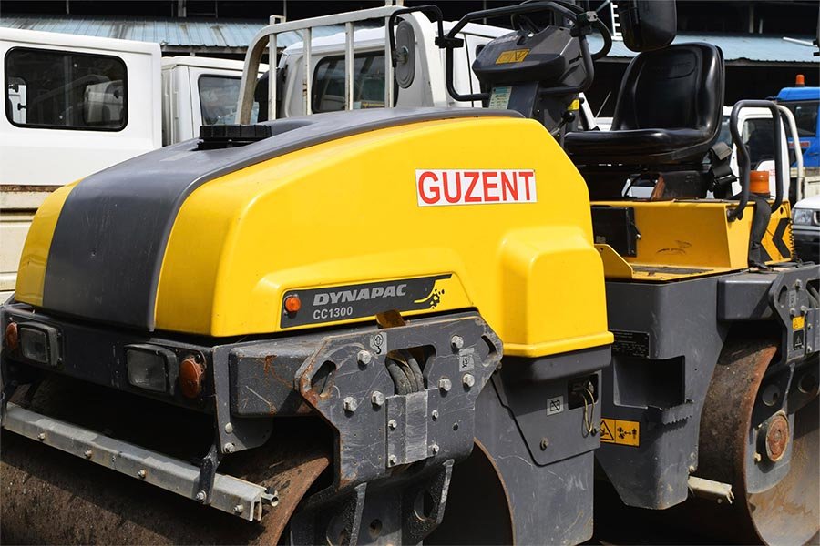 A Dynapac road roller or vibratory compactor at Guzent's equipment yard.